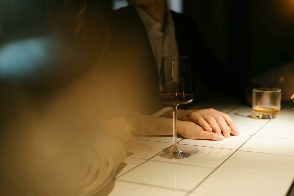 Intimate moment at a bar counter with a couple enjoying wine and atmosphere.